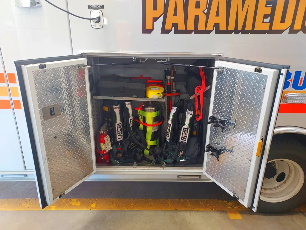 Bin of an ambulance with fire tools inside